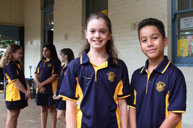 2 Stage 3 students standing in front of another group studnets in C Block