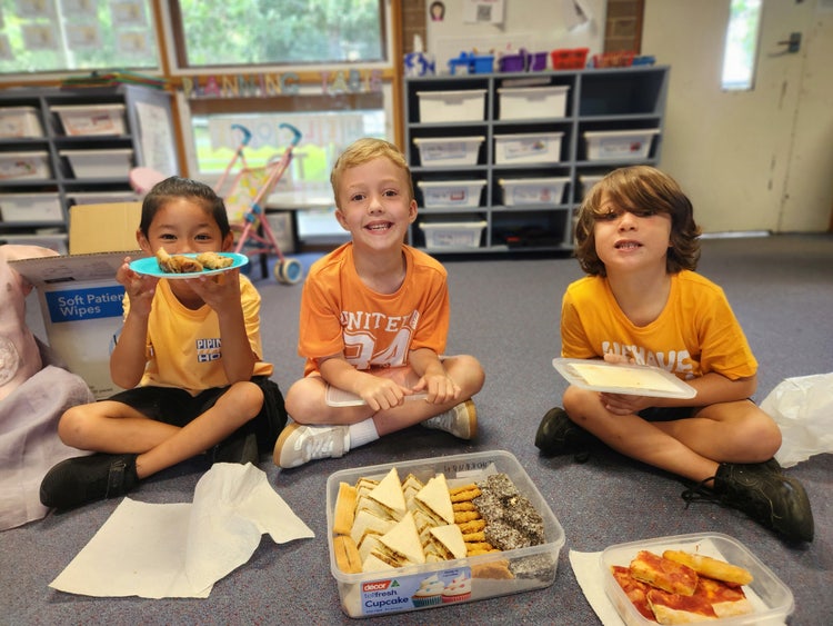 3 Kindergarten students sharing morning tea on Harmony Day